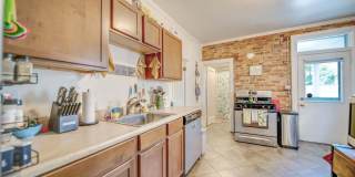 Charming 5-Bedroom Home with Exposed Brick and Modern Upgrades Gallery 8