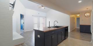 Top floor completely remodeled condo with open concept, vaulted ceilings and an electric fireplace! Gallery 1