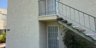 2BR/1BA Lakeside ground floor condo with 1 car detached garage, 1 uncovered parking space & community pool. Gallery 1