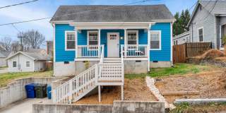 Cheery downtown bungalow with stunning finishes and fenced back yard. Gallery 1