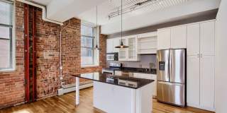 Evolve Real Estate: Bright Industrial-Style 1BD/1BA Condo in LoDo, Nearly 1,160 Sq Ft, Balcony and Rooftop Views! Gallery 1