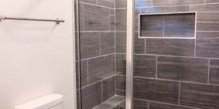 Modern Living Redefined with Stone Fireplace, Gray Cabinetry, Spa Inspired Primary Suite and Covered Outdoor Retreat Gallery 14