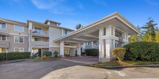 Quiet SE-corner 2 bed / 2 bath at Le Chateau with greenbelt views, two private suites, and oversized parking. Gallery 1