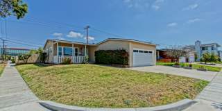 PARTIALLY REMODELED, CHARMING & BRIGHT HOME ON A LARGE CORNER LOT W/ FRONT PORCH, LARGE FRONT LAWN & REAR PATIOS CLOSE TO MALL, SHOPPING & MINS TO BEACH! Gallery 1