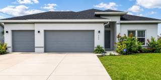 Modern Cape Coral Home with 3-Car Garage, Designer Upgrades & Flexible 4-Bedroom Layout! Gallery 1
