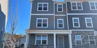 Rental Resort Living! Gorgeous End Unit 3 Story 4 bedroom, 3.5 bathroom Bradley Townhome With Many Windows Featuring a 1st floor Guest Suite, 2 Car Garage, and High Speed Internet Included! Located in Stoneriver, Knightdale, Available Apr 4th! Gallery 1