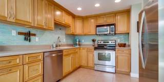 Stunning 2 bed 2 bath top floor condo in gated community with 2 covered parking spaces! Gallery 1