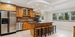 5 BR 4.5 BA home with inground heated pool and extensive hardscape! Gallery 6