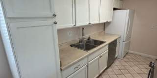 2BR/1BA Lakeside ground floor condo with 1 car detached garage, 1 uncovered parking space & community pool. Gallery 7