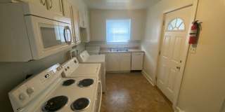 Private carport, in-unit laundry, and the Lakewood strip right outside your door. Gallery 5