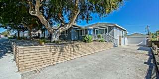 Updated, Bright & Airy 3BR2BA Home + Detached Bonus Room on Spacious Lot w/ Large Front Yard, Huge Rear Yard, Detached Garage w/ Bonus Room & Large Driveway Close to Schools, Shopping, Restaurants, Easy Freeway Acces & 5 Mins to Beach! Gallery 1