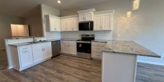 Ranch townhome with 2 stall garage. Spacious 2 bedrooms with walk in closets, 2.5 bathroom, 1st floor laundry Gallery 7