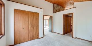 Welcome home! One of a kind, strikingly designed 2-level hillside chalet built on 1 1/2 acres of wooded property with stream surrounded by park land. Gallery 30