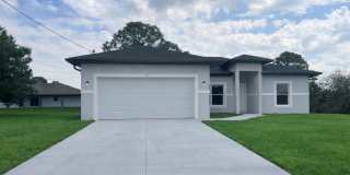 New 4 Bed / 2 Bath / 2 Car Garage Family Retreat in Desirable Lehigh Acres! Gallery 1