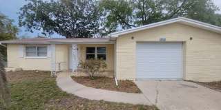 Spacious 3 bed, 2 bath home with fenced yard, screened porch, and oversized garage just minutes from beaches and Tarpon Springs! Gallery 1