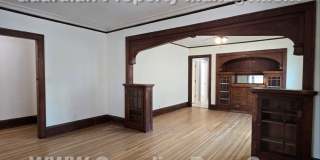 Large main floor duplex unit, Updated Kitchen & Bath, Full Dining Room w/Built-ins + Sunroom, garage stall Gallery 1