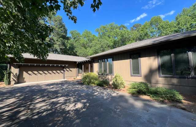 **OFFERING REFUNDABLE APPLICATION FEES** Tranquil and Secluded Raleigh Home with Unique Bonus Features Located on a Large Lot on a Private Street with Plenty of Privacy and Outdoor Space Gallery 1
