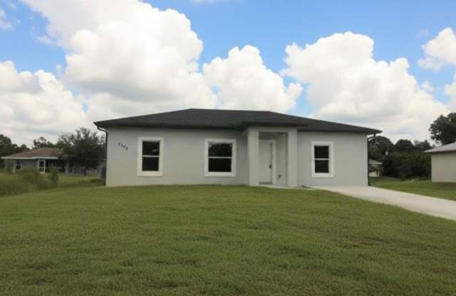 Great location in Lehigh Acres-Three Bedroom 2 bath/ Large Back yard! - 3306 49th Street West, Lehigh Acres, FL 33971