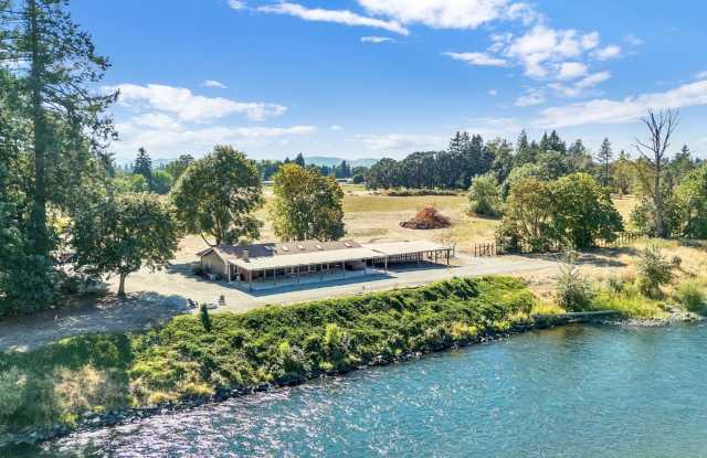 RARE RIVERFRONT HOME WITH LARGE SHOP ON ACREAGE!! Gallery 1