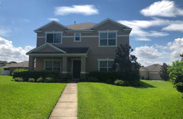 MOVE IN MAY! Great location- in Oaks At Brandy Lake! 5 bed 2.5 bath 2 story home with large bonus room  attached 2 car garage!! Lawn care included!Bring your washer  dryer! Convenient laundry room on 2nd floor!! - 874 Bending Oak Trail, Winter Garden, FL 34787