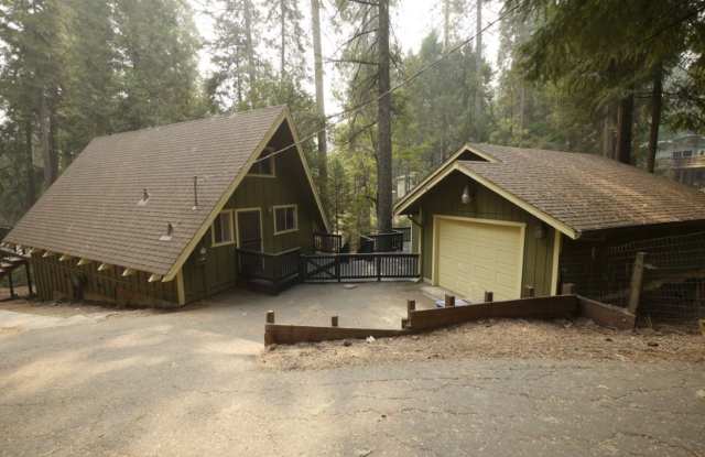 A frame cabin style home with spiral staircase to loft at 16870 Alpine Ln. in Pioneer. photos photos