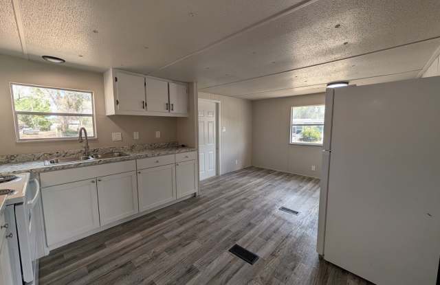 Beautifully renovated 3 bedroom, 1.5 bath home on a spacious .65-acre lot with a fenced backyard and white vinyl privacy fencing. Gallery 1