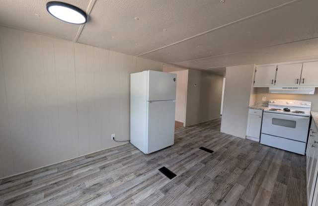Beautifully renovated 3 bedroom, 1.5 bath home on a spacious .65-acre lot with a fenced backyard and white vinyl privacy fencing. photos photos
