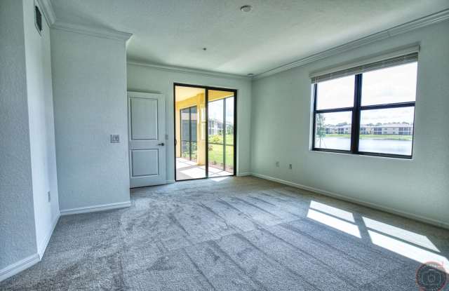 Annual Unfurnished Rental – Coach Home 3 Bedrooms, 2 Baths, 2 Car Garage, with Resort Like Amenities – Gran Paradiso Community! Gallery 1