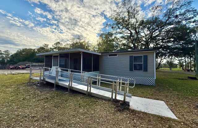 Move-in Ready 3-Bed, 2-Bath Home with Spacious Yard, Screened in Lanai, and Lawncare Included! photos photos