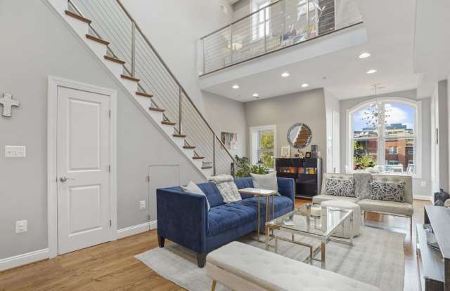 Stunning 3-bedroom, 2.5-bath two-level penthouse with den in historic Shaw, featuring soaring ceilings, a gourmet kitchen, luxurious primary suite, private rooftop deck with city views, gated parking, and easy Metro access. Gallery 3