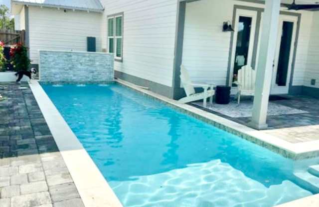 AVAILABLE NOW — Luxur​ious 4BR/2.5BA Heated Pool Home • 1 Mile to the Beach • Pool Service Included • 6-Month  1 Day Option! photos photos