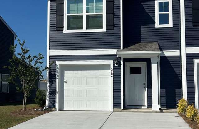 Welcome to this brand new end unit townhome that combines modern convenience with style and charm in Leland! photos photos