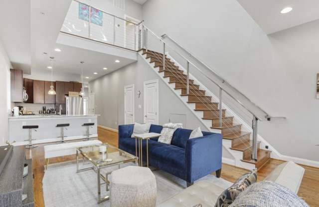 Stunning 3-bedroom, 2.5-bath two-level penthouse with den in historic Shaw, featuring soaring ceilings, a gourmet kitchen, luxurious primary suite, private rooftop deck with city views, gated parking, and easy Metro access. Gallery 4