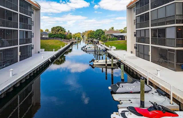 2BR/3BA Bonita Springs Waterfront Condo with Gulf Access, Boat Slips & Covered Parking — $2,500/mo Gallery 1
