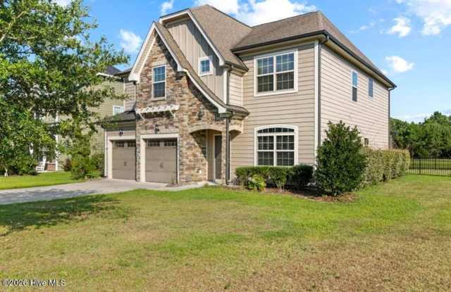 Set along a peaceful pond in the gated community of Mimosa Bay Gallery 3