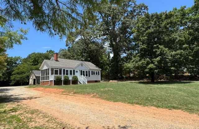 Charming 2 BD - 1 Full BA Home in Greer/Eastside close to Riverside HS, BMW, GSP, Inland Port, Greenville & Spartanburg but with country feel with land & outbuildings. The home sits on a 3/4-acre lot. photos photos