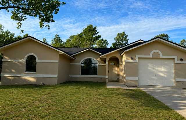 Beautiful 4- Bedroom Home with Arched Windows, Open Floor Plan & One-Car Garage in Silver Springs Shores! photos photos