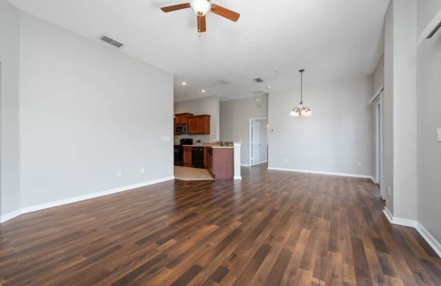WAKE UP TO PEACEFUL LAKE VIEWS in this spacious 2-bedroom, 2-bath condo with an attached 1-car garage in the desirable East Park community near Lake Nona Gallery 4