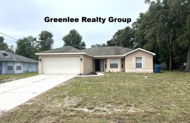 Spacious 3-bedroom, 2-bath Spring Hill home featuring an updated kitchen, no carpet, a 2-car garage, and a large fenced backyard with covered porch—perfect for entertaining! photos photos