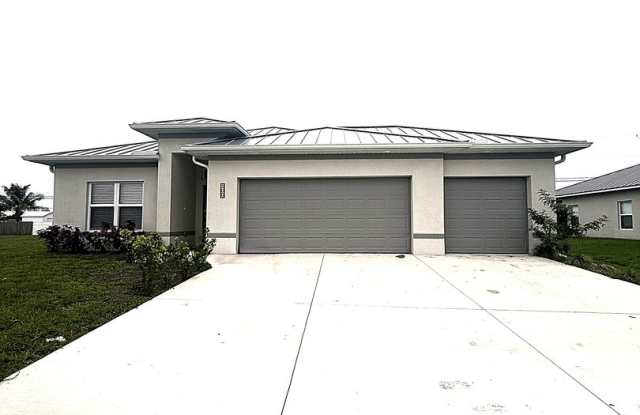 Modern 4-Bedroom Home with 3-Car Garage  Fenced Yard | New Construction in Prime Cape Coral Location! photos photos