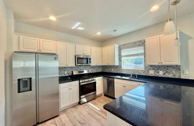 **OFFERING REFUNDABLE APPLICATION FEES & $150 MOVE IN PROMOTION** Modern 4BD, 2.5BA Knightdale Home with a Fenced Yard & Screened Patio Gallery 3