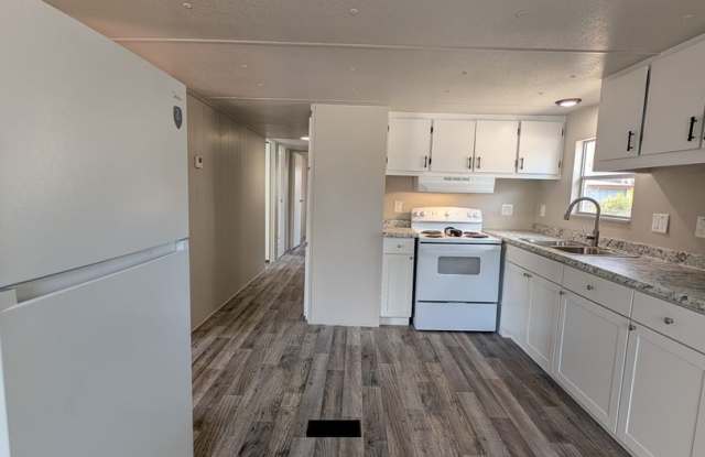 Beautifully renovated 3 bedroom, 1.5 bath home on a spacious .65-acre lot with a fenced backyard and white vinyl privacy fencing. Gallery 4