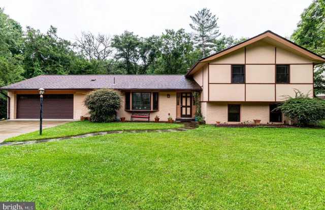 This elegant and unique three-level split home is situated on a tranquil cul-de-sac and backs to beautiful wooded parkland. - 9907 Corsica Street, Oakton, VA 22181
