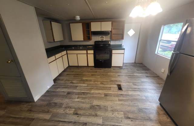 Freshly painted spacious 2-bedroom 1-bath home with a screened porch and storage shed. Gallery 3