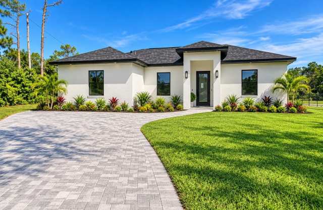 Brand-New Pool Home with a Legal Mother-in-Law Suite in Lehigh Acres FL! Gallery 1