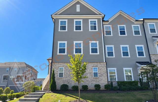 Welcome to this 4-Bedroom End-Unit Townhome with Guest Suite, 2-Car Garage & Community Pool located in Savaan Townhome, Cary, Available Now! Gallery 1