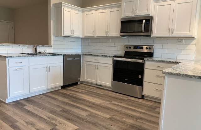 Zero entry ranch townhome with 2 stall garage. Spacious 2 bedrooms with walk in closets, 2.5 bathroom, 1st floor laundry Gallery 1