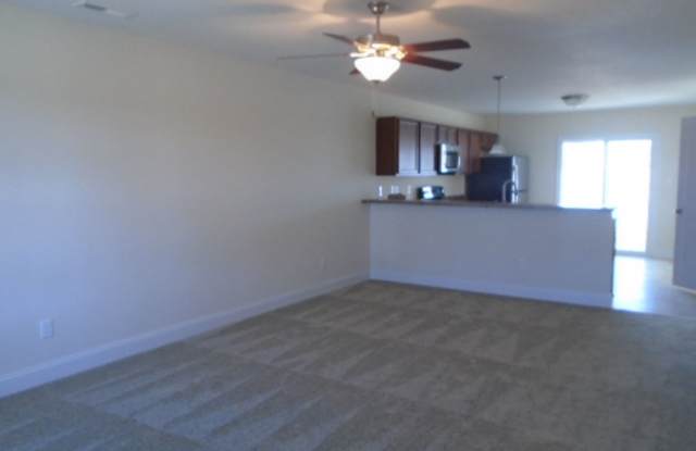 Featuring 2 bedrooms and 2.5 bathrooms. The main level features a welcoming living area, a kitchen with ample cabinet space, and a convenient half bathroom. Gallery 3