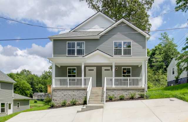 Two Story Duplex With Hardwood Flooring and White Cabinetry photos photos
