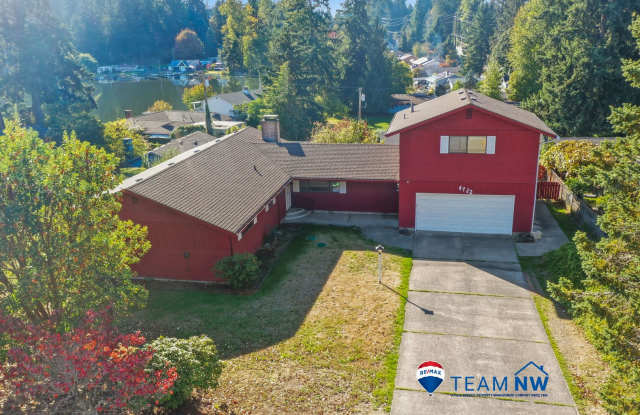 MOVE IN READY NOW! Peek a boo view of Pattison Lake - 3 bedrooms plus huge bonus room - bring your home business! Gallery 1